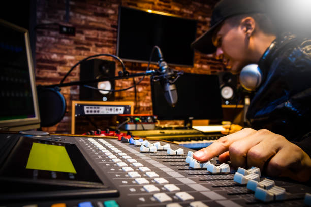 Music producer working at a mixing desk in a recording studio